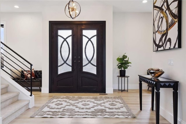 entryway with french doors and light wood-type flooring