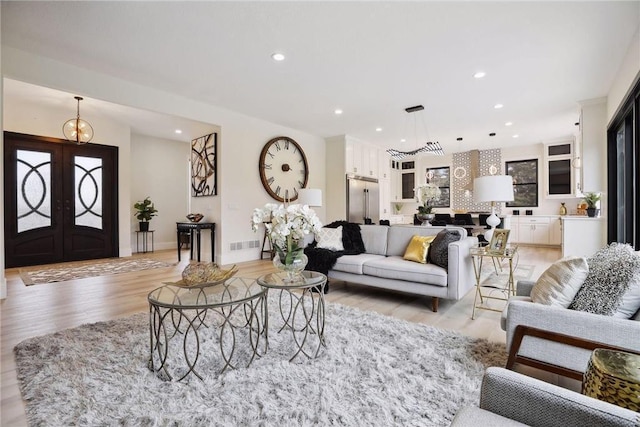 living room featuring light hardwood / wood-style flooring and french doors