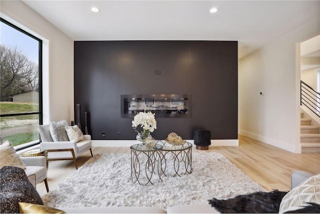 living room with plenty of natural light and light hardwood / wood-style floors