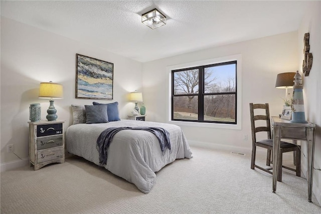 carpeted bedroom featuring a textured ceiling