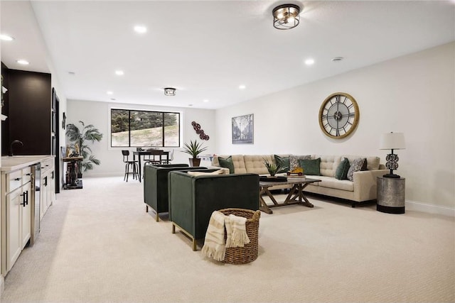 carpeted living room with sink