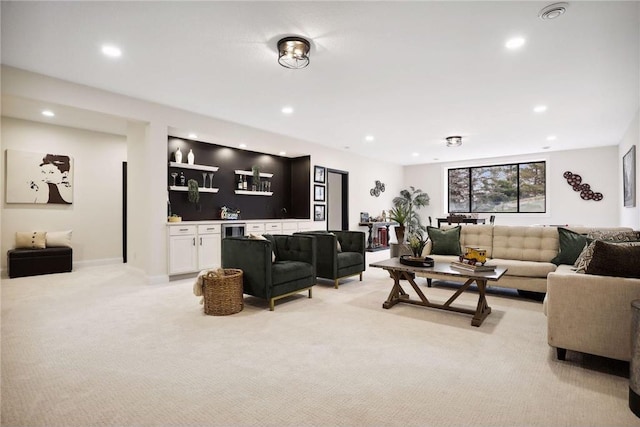 carpeted living room with bar and beverage cooler