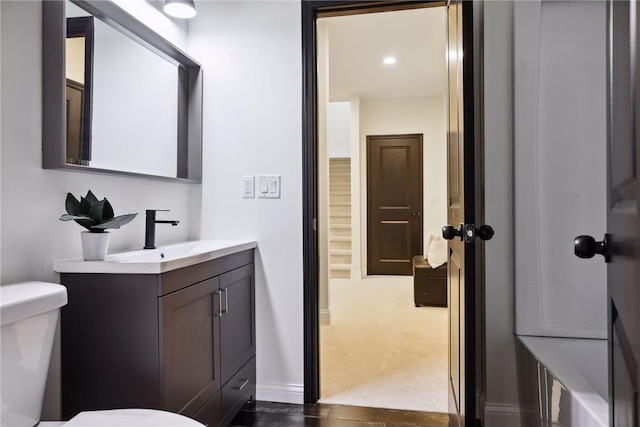 bathroom featuring vanity and toilet