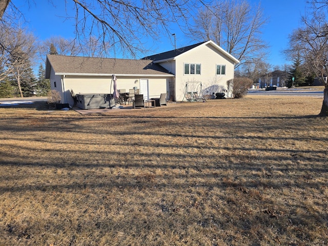 back of property featuring a yard and a patio