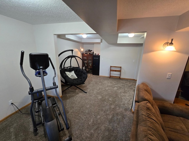 workout area with carpet flooring and a textured ceiling