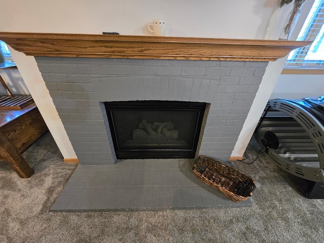 details featuring a brick fireplace and carpet