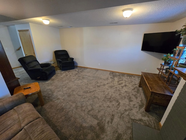 carpeted living room featuring a textured ceiling