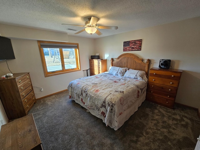 bedroom featuring dark carpet, a textured ceiling, and ceiling fan