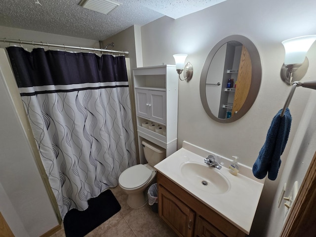 bathroom with toilet, a shower with curtain, a textured ceiling, vanity, and tile patterned flooring