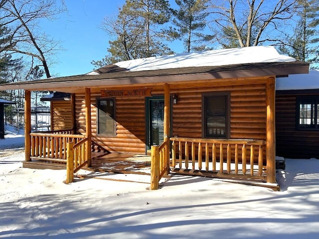 log cabin with a porch