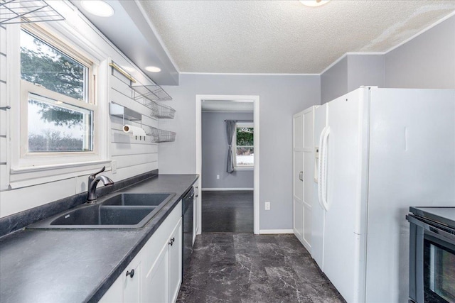 kitchen with sink, a textured ceiling, stainless steel electric range, white fridge with ice dispenser, and white cabinets