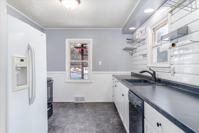 kitchen featuring white cabinetry, dishwasher, sink, white refrigerator with ice dispenser, and a textured ceiling