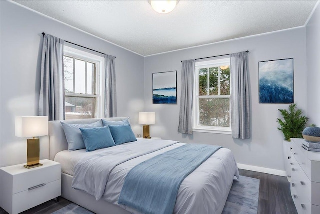 bedroom featuring crown molding, dark hardwood / wood-style floors, and a textured ceiling