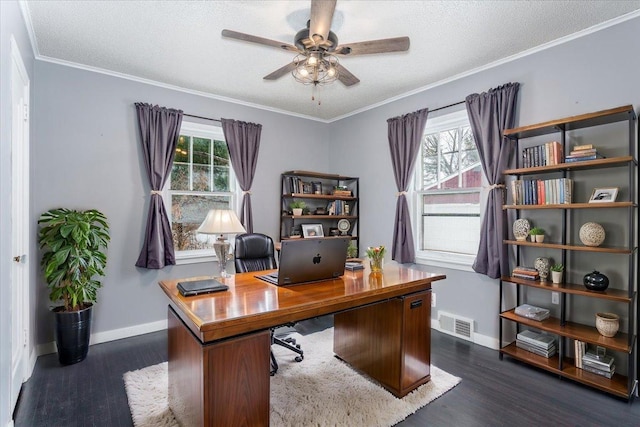 office area featuring ceiling fan, dark wood-type flooring, ornamental molding, and a healthy amount of sunlight