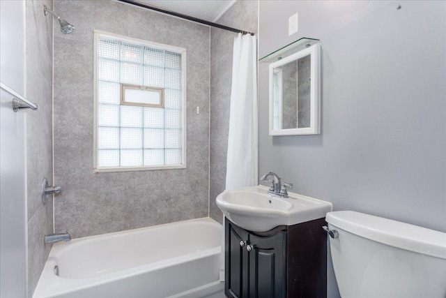 full bathroom with vanity, shower / tub combo, and toilet