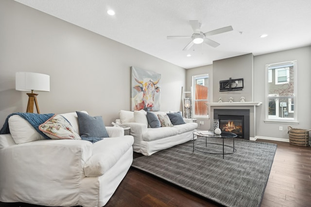 living room featuring ceiling fan, dark hardwood / wood-style flooring, and a wealth of natural light