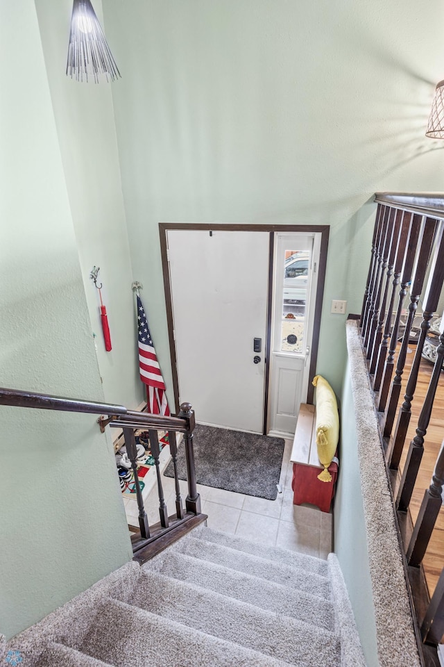 stairway with tile patterned flooring