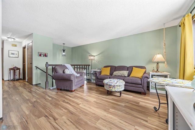 living room featuring wood-type flooring and a textured ceiling