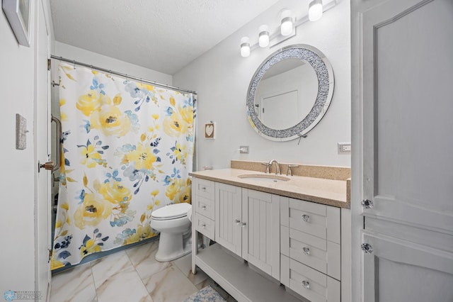 bathroom featuring vanity, toilet, and a textured ceiling