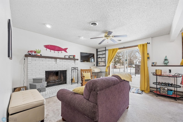 carpeted living room with ceiling fan, a fireplace, and a textured ceiling