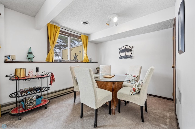 carpeted dining room with a baseboard radiator, beam ceiling, and a textured ceiling