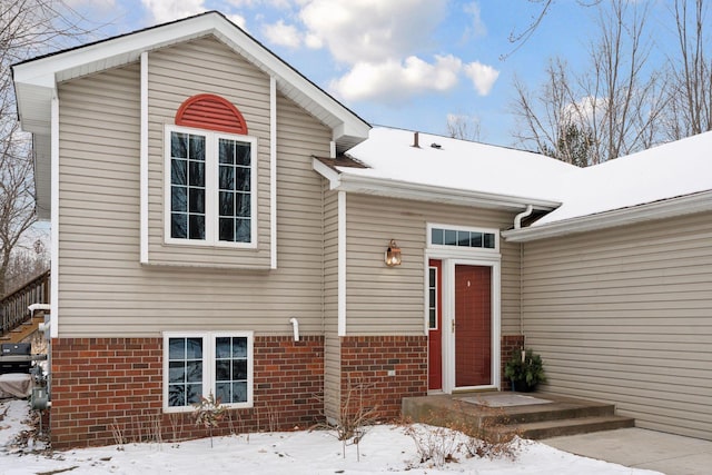 view of snow covered property entrance