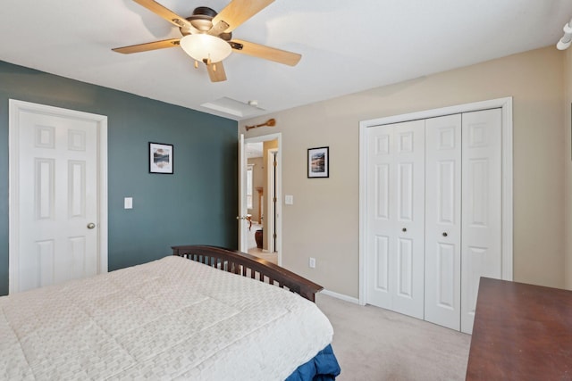 carpeted bedroom with ceiling fan and a closet