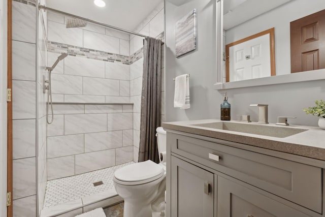 bathroom featuring vanity, toilet, and curtained shower