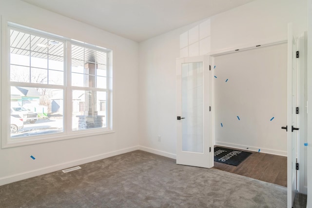 carpeted spare room with french doors