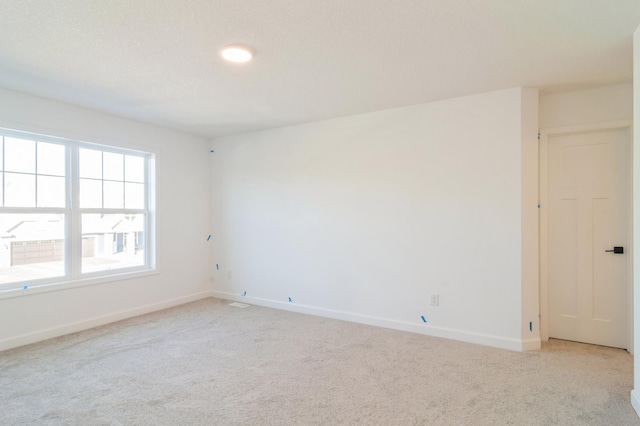 unfurnished room with light colored carpet