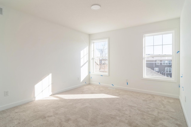 unfurnished room featuring light colored carpet