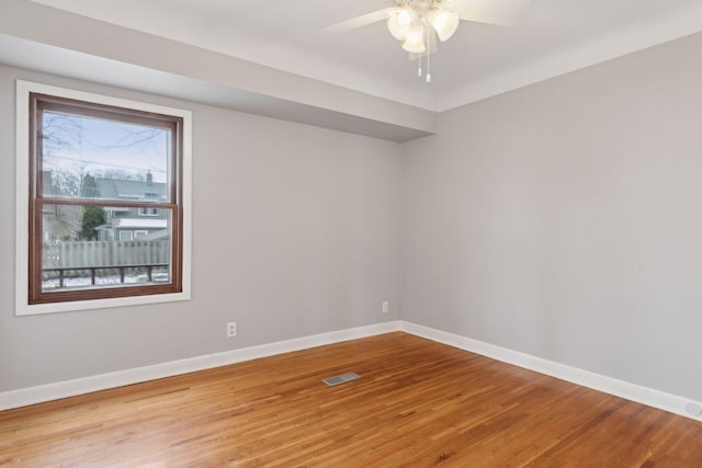 unfurnished room with hardwood / wood-style floors and ceiling fan