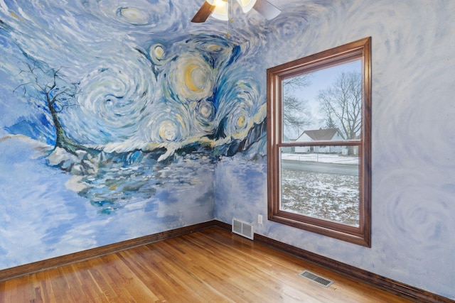 empty room featuring hardwood / wood-style flooring and ceiling fan