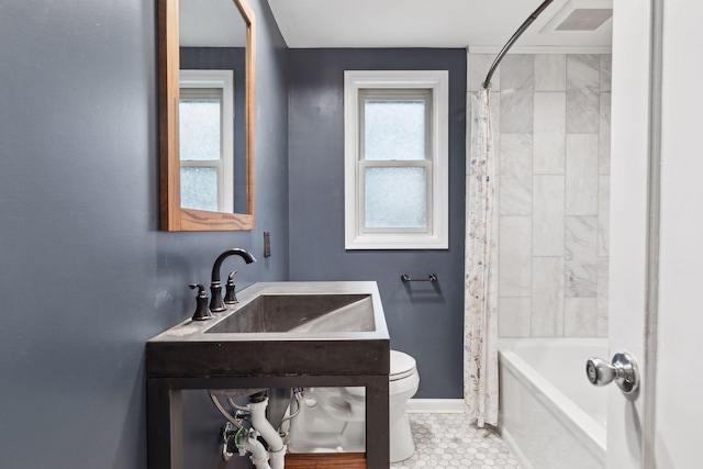 full bathroom with shower / tub combo, sink, and toilet