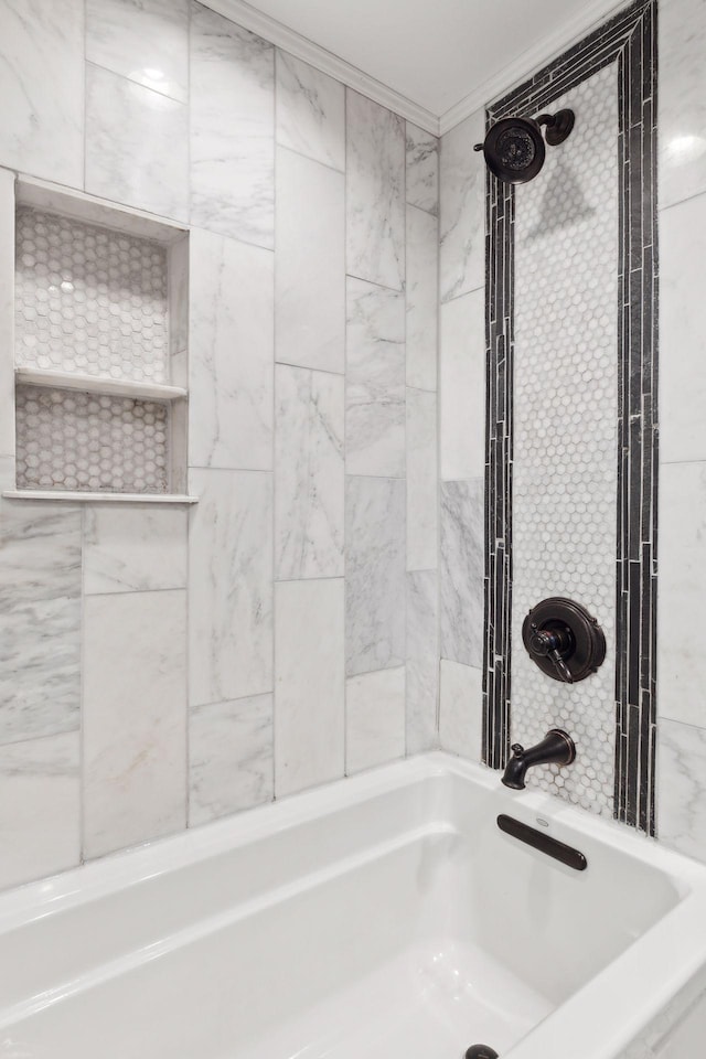 bathroom featuring crown molding and tiled shower / bath combo