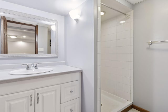 bathroom with vanity and a tile shower