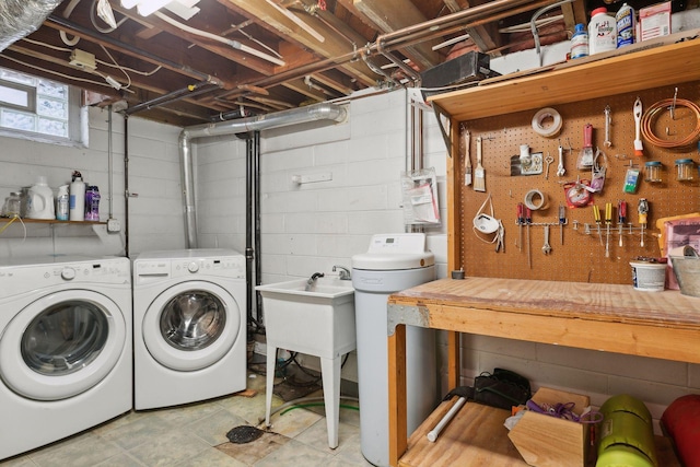 washroom featuring washing machine and dryer and a workshop area