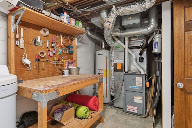 utility room featuring water heater and heating unit