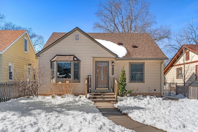 view of front of home featuring fence and roof with shingles