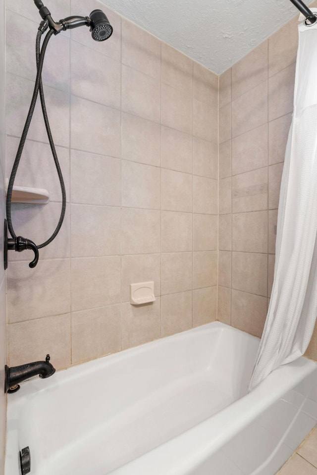 full bathroom with tile patterned floors, a textured ceiling, and shower / bath combo