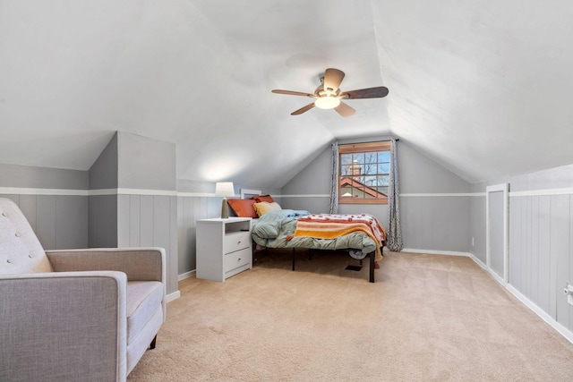 bedroom with ceiling fan, lofted ceiling, and carpet