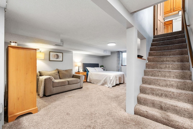 bedroom featuring a textured ceiling and carpet