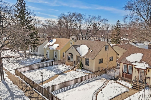 view of front facade with a residential view, entry steps, and fence private yard