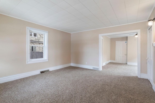 unfurnished room with crown molding and carpet flooring