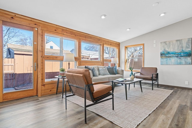 living room featuring hardwood / wood-style flooring and vaulted ceiling