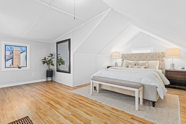 bedroom with wood-type flooring and lofted ceiling