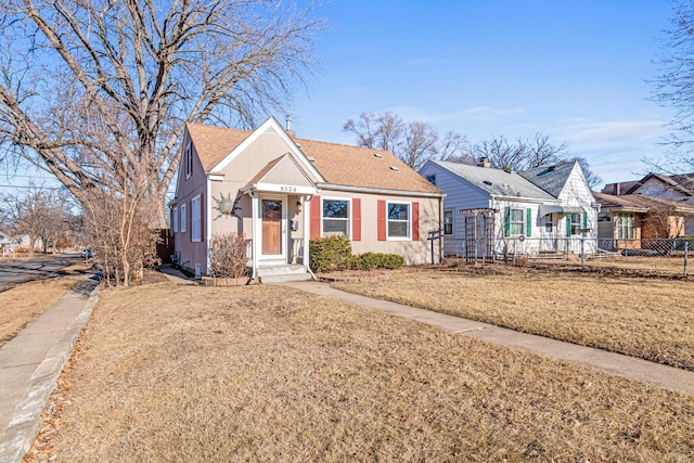 bungalow-style home featuring a front yard