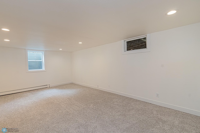 basement featuring a baseboard radiator and carpet