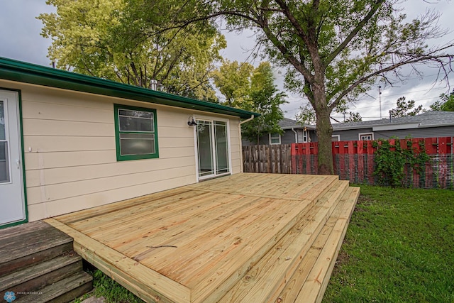 wooden terrace with a lawn