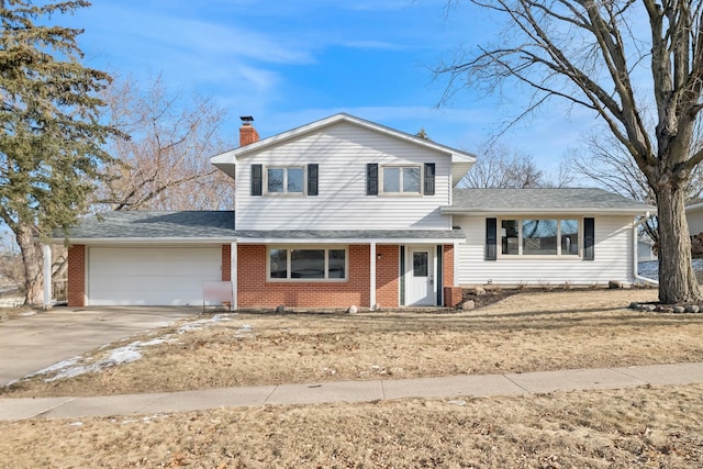 tri-level home featuring a garage and a front yard